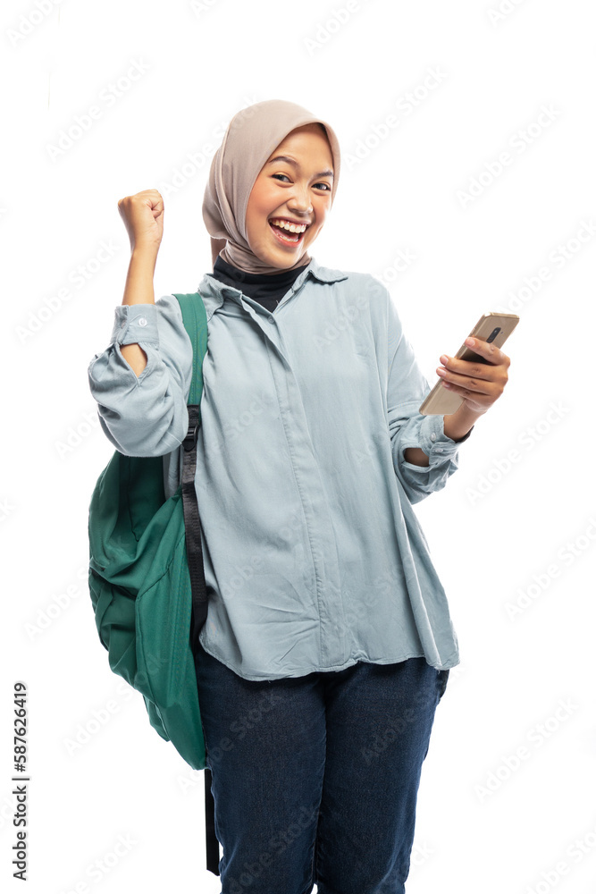 happy student of hijab woman standing using phone with backpack in isolated background