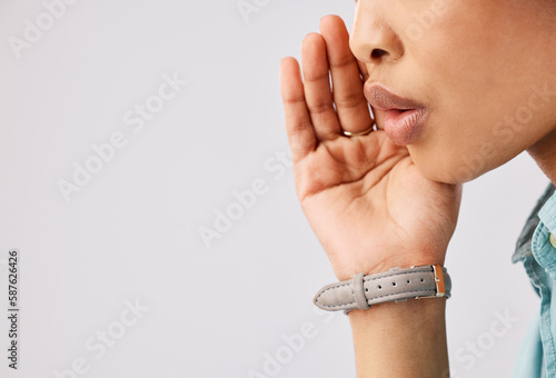 Fototapeta Woman, secret and hand over mouth on mockup in studio against a gray background to whisper gossip or a rumor