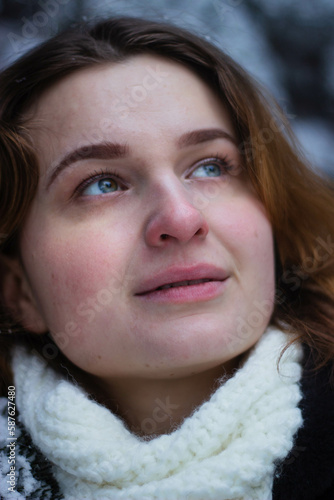 Beautiful girl close-up on the street in winter