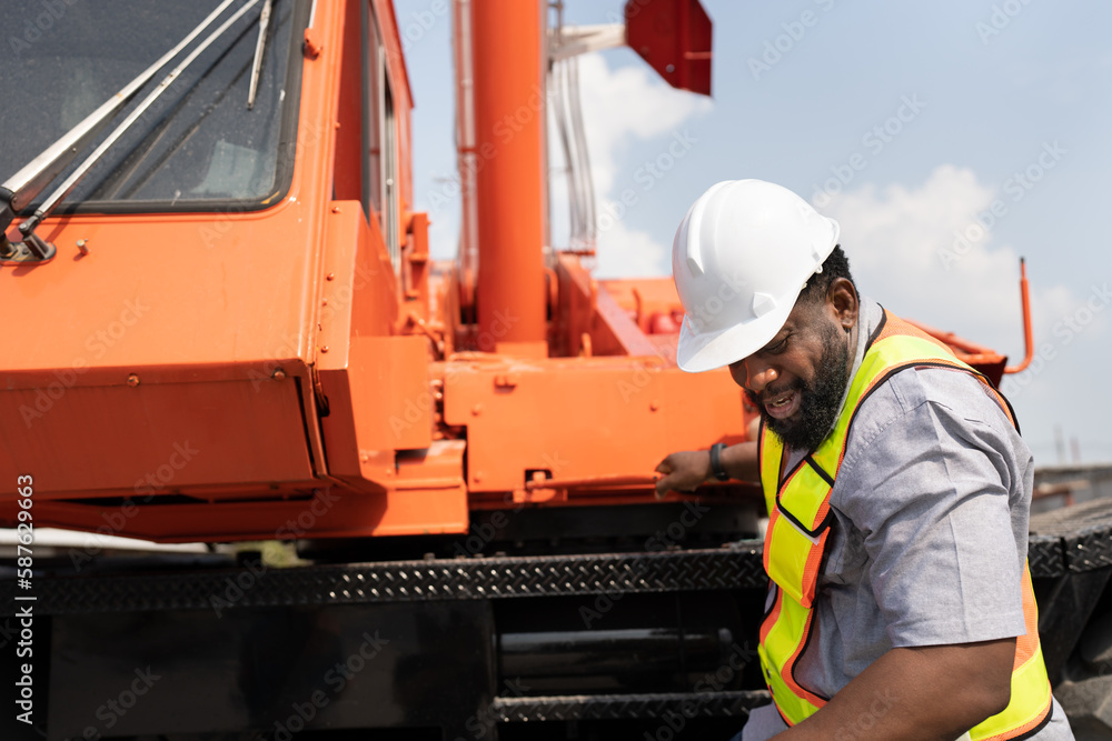 African American Engineer man with crane truck background at site work African American Engineer man with crane truck background at site work