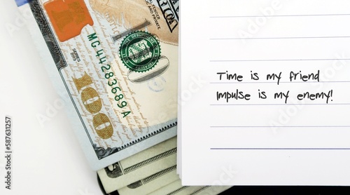 Photos cash dollar money with text written TIME IS MY FRIEND , IMPULSE IS MY ENEMY - to