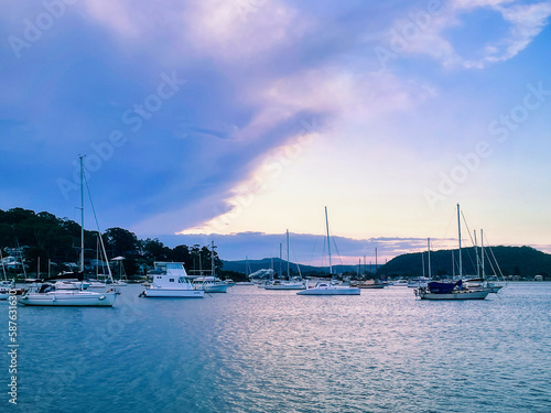 Beautiful scenery at sunset in the small resort town of Killcare with boats on the water in the foreground on the Central Coast, NSW, Australia. © Daniela Photography