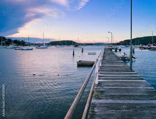 Seascape perspective at sunset in the small resort town of Killcare with the pier and marina in the foreground on the Central Coast, NSW, Australia. © Daniela Photography