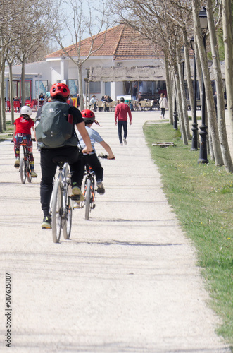 Family riding a bike in sunny day © juancarlos