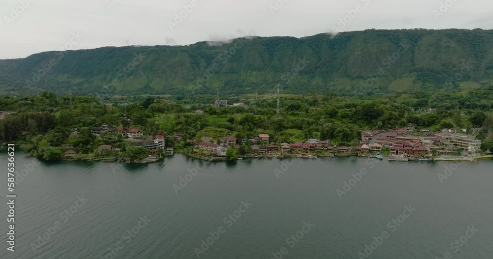 Lake Toba and Samosir Island. Tuk Tuk traditional village and tourist destination. Sumatra, Indonesia. Tropical landscape. Lake Toba and Samosir Island. Tuk Tuk traditional village and tourist destination. Sumatra, Indonesia. Tropical landscape.