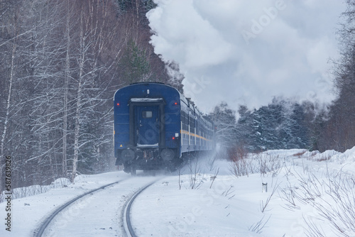 Retro steam train moves at winter morning time.