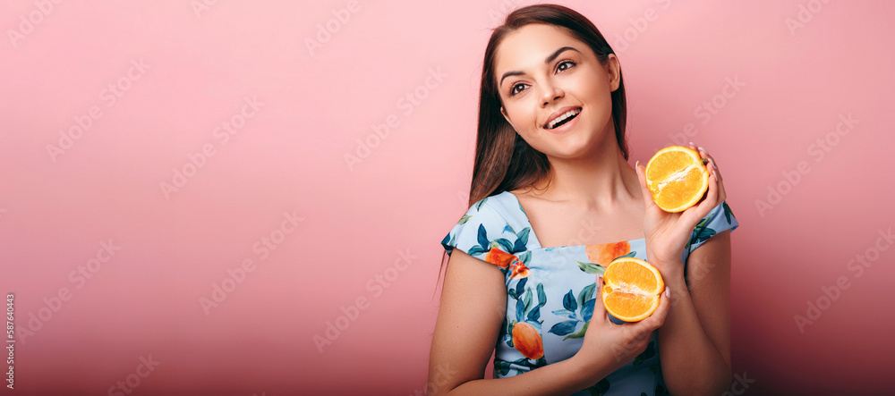 Portrait of funny playful young woman holding halves of citrus orange juicy fruits Portrait of funny playful young woman holding halves of citrus orange juicy fruits