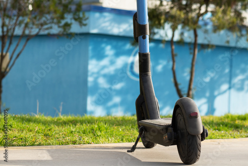 kick scooter stands on the bike path in the city on the street in summer,driving safety in the park