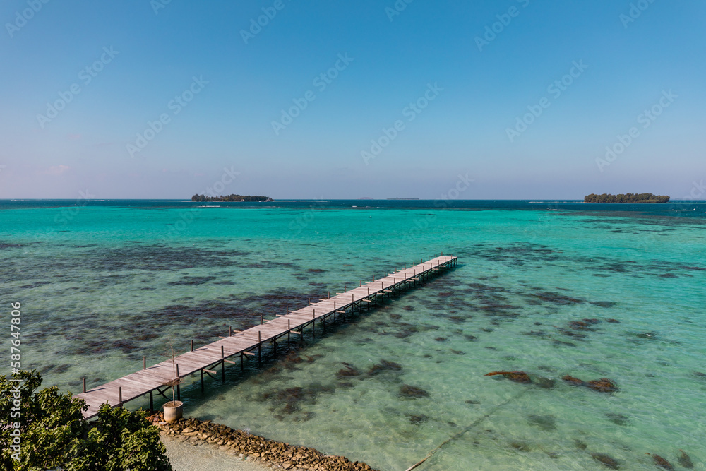 Amazing turquoise lagoon with jetty on Karimunjava tropical island, Indonesia