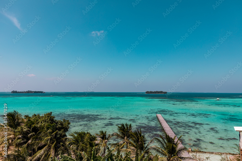 Amazing turquoise lagoon with jetty on Karimunjava tropical island, Indonesia