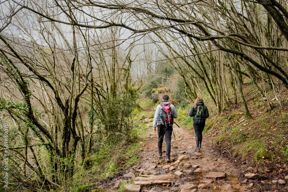 Naklejka premium Young couple hiking or trekking in the Ibardin Valley in the Basque Country