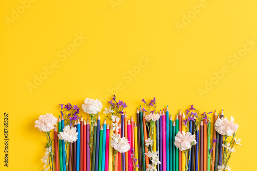 School stationary with flowers on yellow background . International children’s day concept.