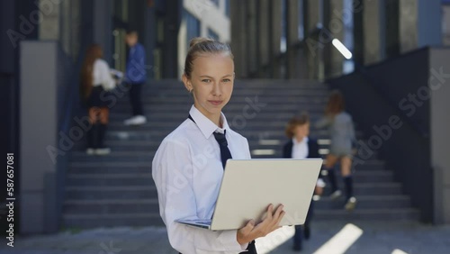 Wallpaper Mural Portrait of the Young Little Businesswoman Kid Using Laptop Standing Outside Near Office Building. Little Specialist, Office Worker, Data Analysis, Company Owner, Entrepreneur. Future Profession Torontodigital.ca