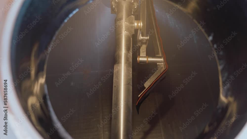 Huge steel brewing tank close-up. Equipment at the brewery. Technological process of brewing. Huge steel brewing tank close-up. Equipment at the brewery. Technological process of brewing.