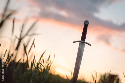Obraz na płótnie The ancient sword stuck in the ground background.