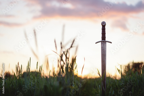 The ancient sword stuck in the ground background.