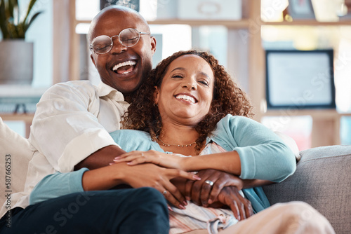 Billede på lærred Couple, hug and laughing on sofa portrait in home living room, bonding and having fun