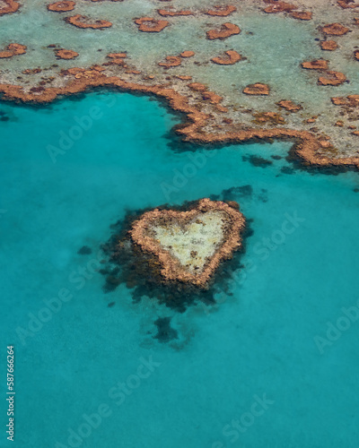 Heart Reef in the Whitsundays Queensland Australia. Famous reef that is shaped like a heart. The Great Barrier Reef aeria is heavily impacted by climate change.