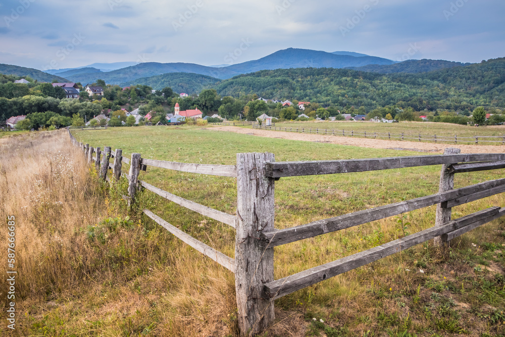 Cloudy morning in a small village in the mountains. Territory fenced with a deevyannim fence for livestock entry. Country road in the mountains. Carpathians. Polyana. Ukraine