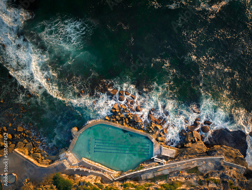 Aerial drone view of Bronte Ocean Pool in Sydney during sunrise in soft early morning light, New South Wales Australia photo