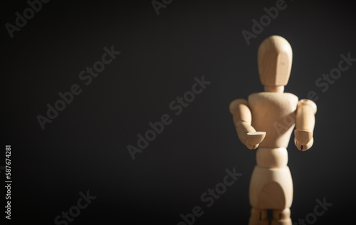 Wooden human figure on the grey background.