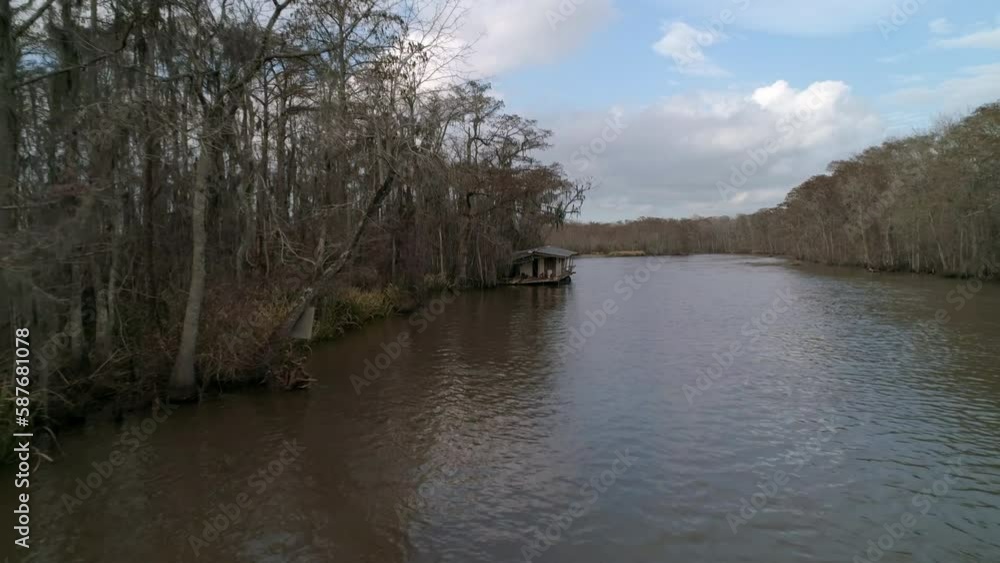 Aerial: Drone Forward Shot Of Rippled River Amidst Bare Trees Under Cloudy Sky - New Orleans, Louisiana Aerial: Drone Forward Shot Of Rippled River Amidst Bare Trees Under Cloudy Sky - New Orleans, Louisiana
