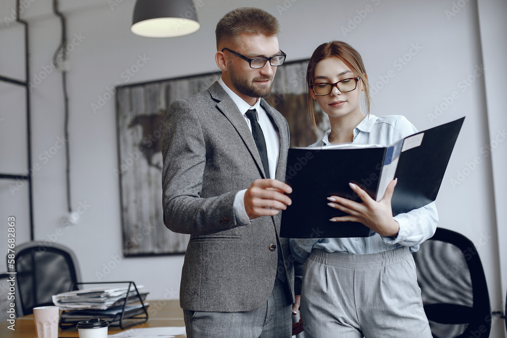 Man and woman read a business contract