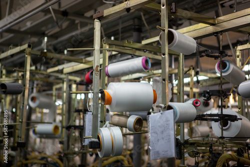 Textile industry with knitting machines in factory. Textile industry with a loom on the production of kapron tights.