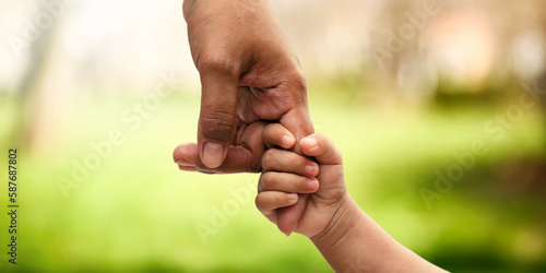 фотографія Closeup rear view of mother and a child hands holding together