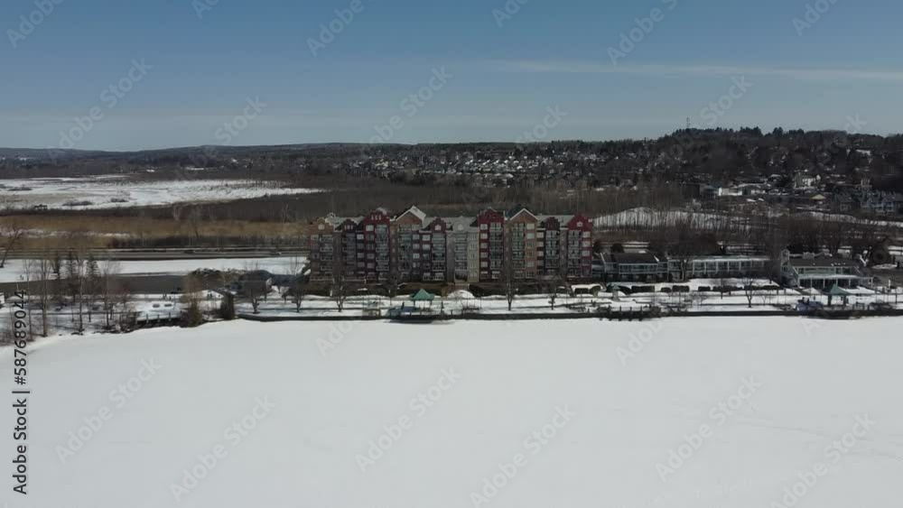 Flying over part of the city of Magog in the Estrie region in winter in Quebec Flying over part of the city of Magog in the Estrie region in winter in Quebec