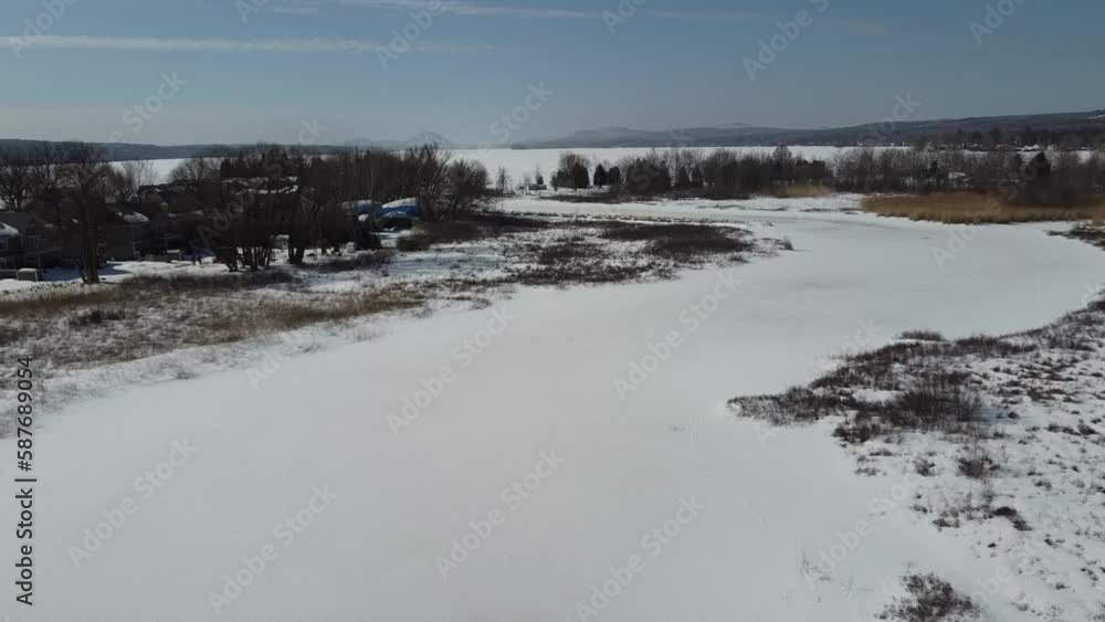 Flying over the cherry river in the Estrie region in winter in Quebec Flying over the cherry river in the Estrie region in winter in Quebec