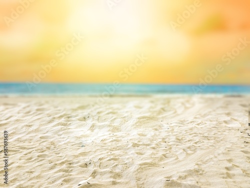 Natural scenery of yellow sky and white sandy beach. Selective focus on sand. Blurred natural background