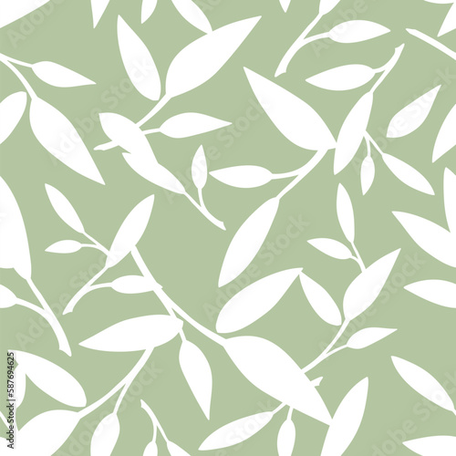 Floral seamless pattern with leaves. White leaves silhouettes on a green background. Vector green and white seamless background 