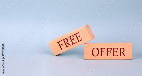 FREE OFFER text on the wooden block, blue background