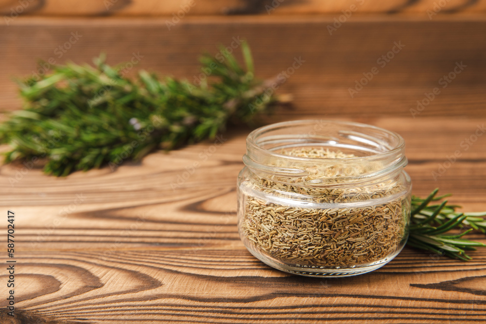 Fresh rosemary and dry spice in a plate and spoons on a brown textured background. Fresh spice herbs. Seasoning for meat and fish. Recipe.Organic bouquet of fresh rosemary on the table.Place for text. Fresh rosemary and dry spice in a plate and spoons on a brown textured background. Fresh spice herbs. Seasoning for meat and fish. Recipe.Organic bouquet of fresh rosemary on the table.Place for text.