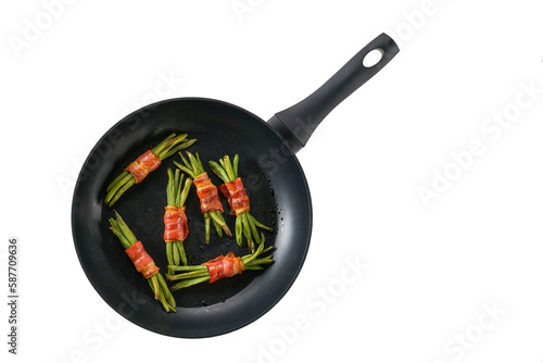 Pan with baked appetizer, bundles of green beans wrapped in bacon isolated on a white background. Top view. photo