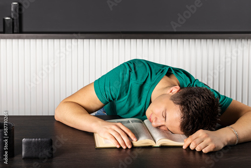 Portrait of attractive young businessman reading at workplace. Education concept