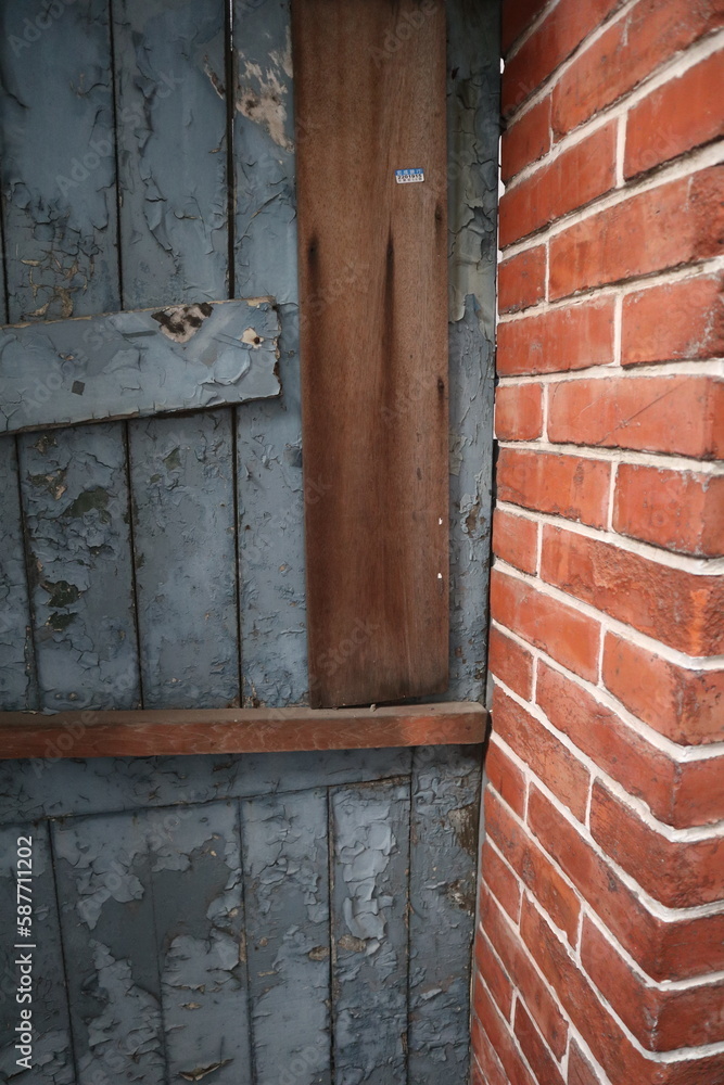 aged blue wooden door with red bricks wall design for traditional interior style aged blue wooden door with red bricks wall design for traditional interior style