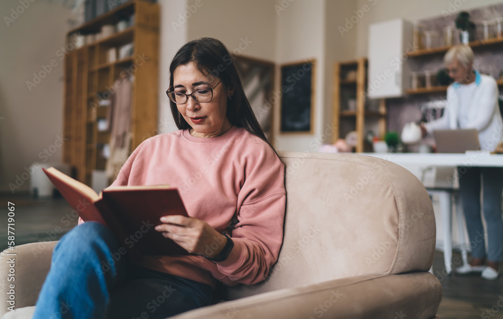 Positive Asian elderly woman busy with reading book Positive Asian elderly woman busy with reading book