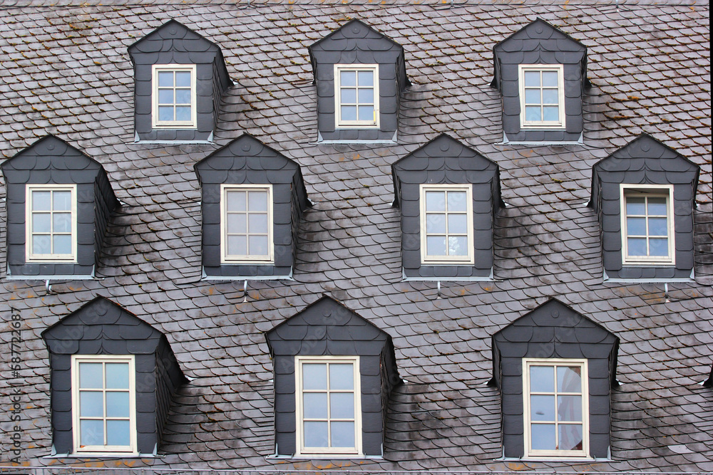 Fototapeta premium Attic windows on the roof of an old building