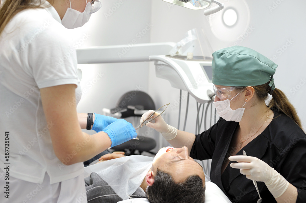 Surgery in a dental clinic. The dentist surgeon stitches the wound in the patient's mouth. stitch up the wound dentist High quality 4k footage Surgery in a dental clinic. The dentist surgeon stitches the wound in the patient's mouth. stitch up the wound dentist High quality 4k footage