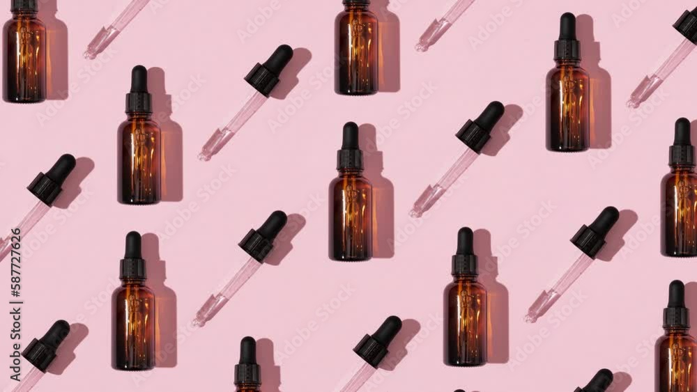 Simple face skincare pattern animation made with dark brown glass serum or essential oil bottle and dropper on pastel pink background. Minimal fresh cosmetic product aesthetic.