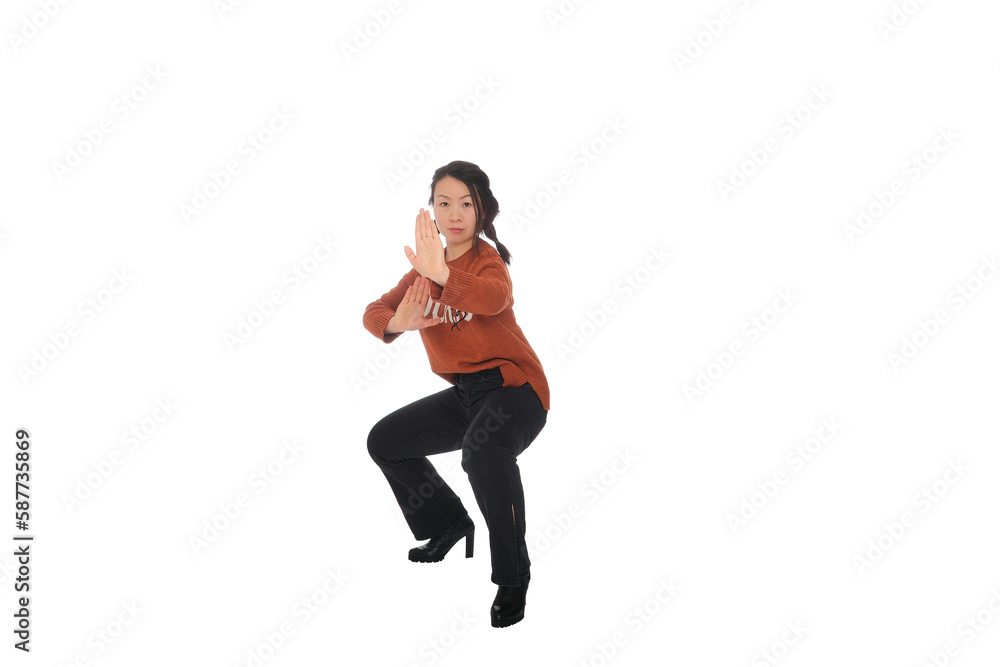 Asian young woman doing martial arts in everyday casual street clothing Asian young woman doing martial arts in everyday casual street clothing