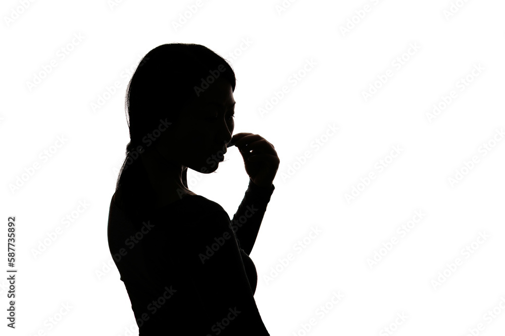 Black backlit silhouette of head and shoulders of an oriental woman from the side outlined by light Black backlit silhouette of head and shoulders of an oriental woman from the side outlined by light