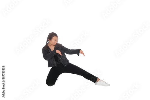Asian young woman doing martial arts in everyday casual street clothing