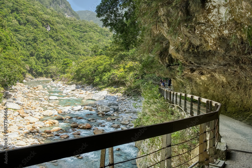 Fototapeta premium Walking path built into side of mountain on Shakadang trail in Taroko Gorge, Taroko National Park, Taiwan