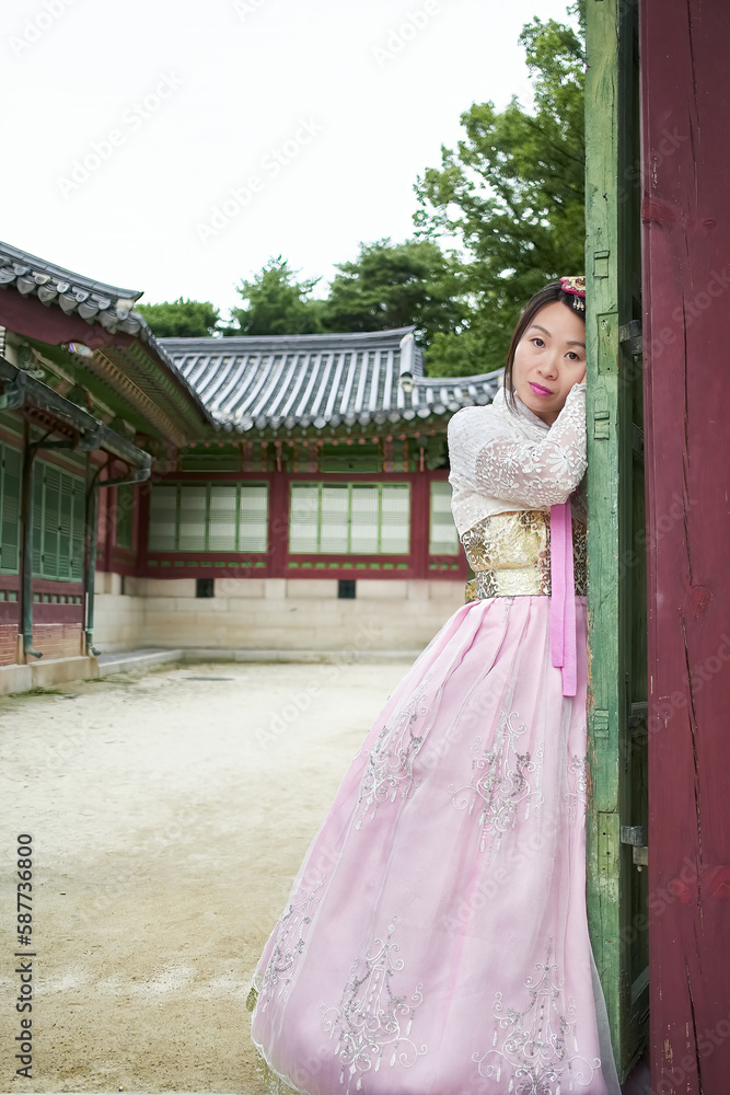 Fototapeta premium Asian woman wearing a pink traditional hanbok dress in Changdeok