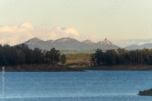 Landscape at sunset with the Castle of Puebla de Alcocer at the top of the mountain. Photo taken from the swamp of orellana la vieja. Ideal place to relax. Extremadura. Spain