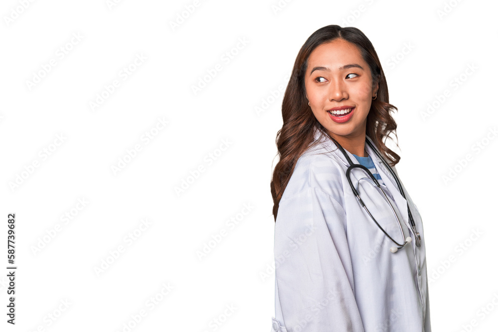 A young asian doctor woman looks aside smiling, cheerful and pleasant. A young asian doctor woman looks aside smiling, cheerful and pleasant.