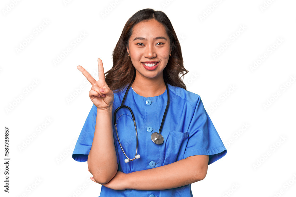 A young nurse chinese woman showing number two with fingers. A young nurse chinese woman showing number two with fingers.